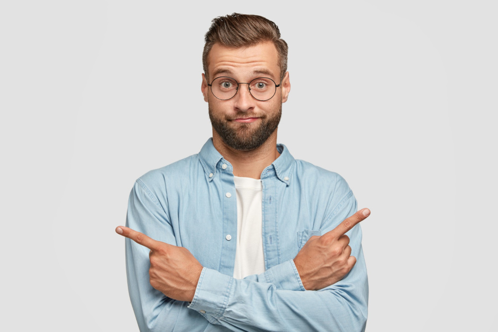 hesitant-clueless-man-crosses-hands-chest-indicates-with-index-fingers-different-sides-directions.jpg
